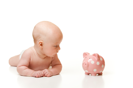 A Cute Baby Looking at Piggy Bank