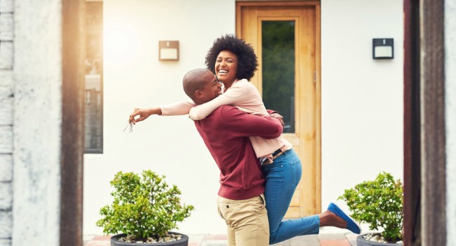 Shot of a young couple celebrating the move into their new house