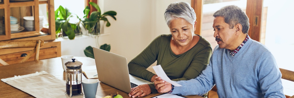 Finance, laptop and senior couple with bills, paperwork and receipt documents for life insurance. Retirement, fintech and elderly man and woman on computer for mortgage payment, investment and budget