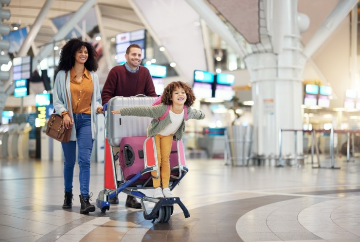 Young multi-racial family at the airport.