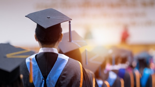 Graduates standing at ceremony