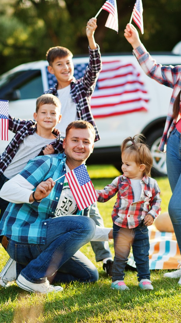 Family celebrating Fourth of July at a park.