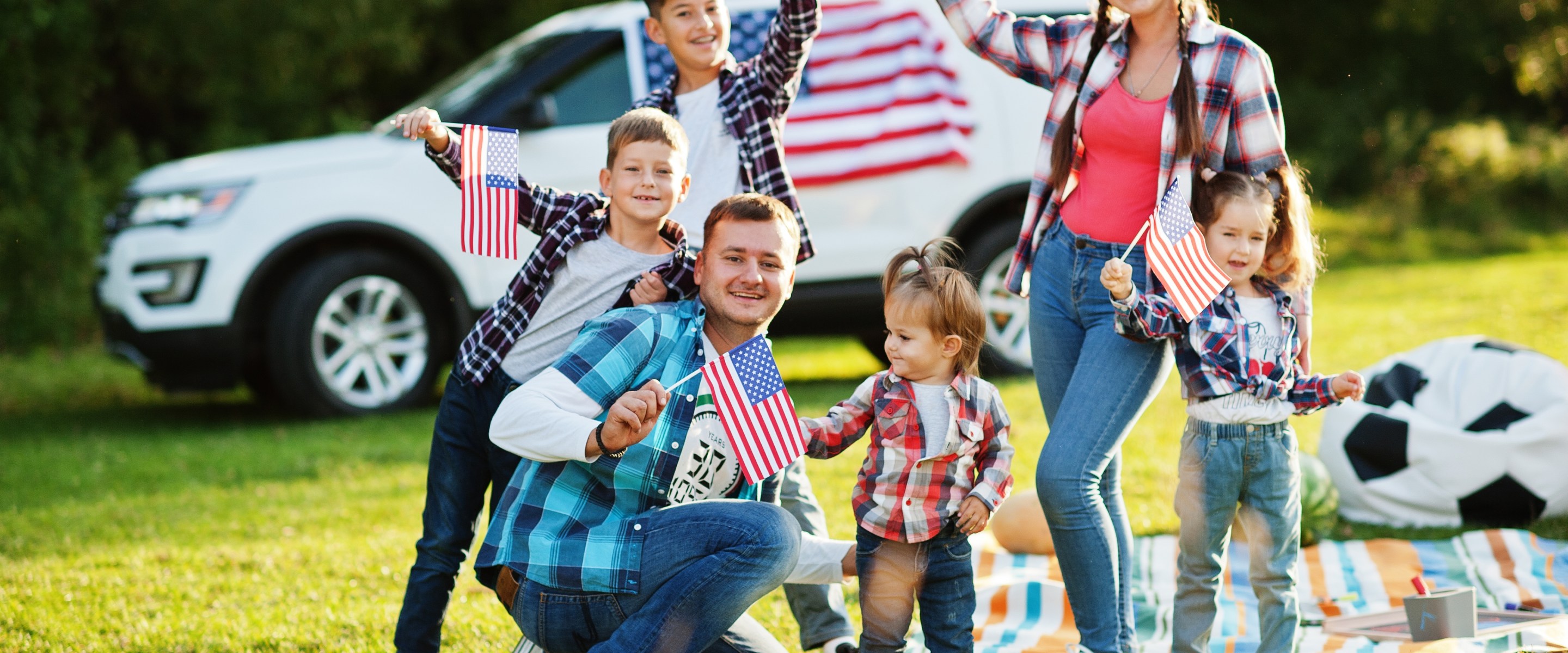 Family celebrating Fourth of July at a park.