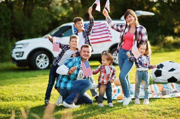 Family celebrating Fourth of July at a park.