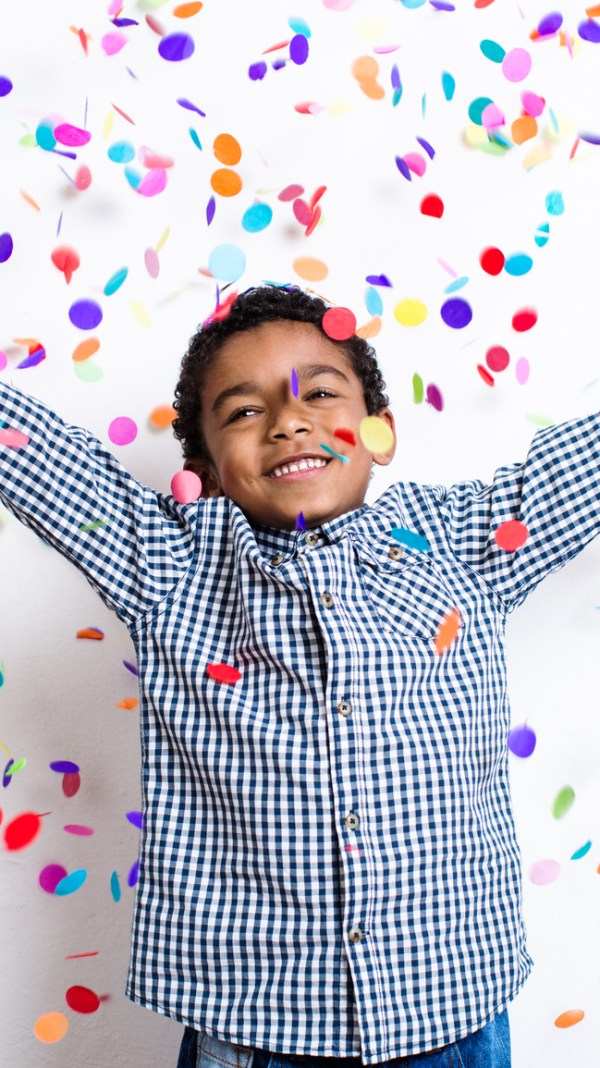 Boy celebrating filing taxes with confetti