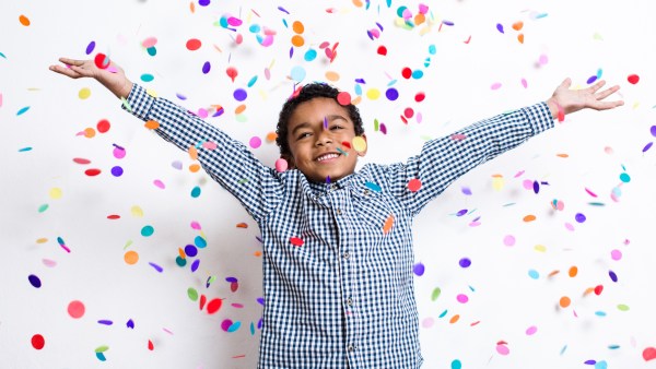 Boy celebrating filing taxes with confetti