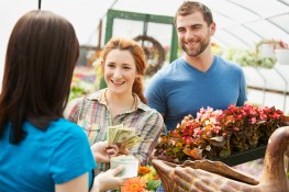 Extensive series with shoppers and growers in a plant or flower nursery. Multi-ethnic group includes Caucasians and Asian Americans.