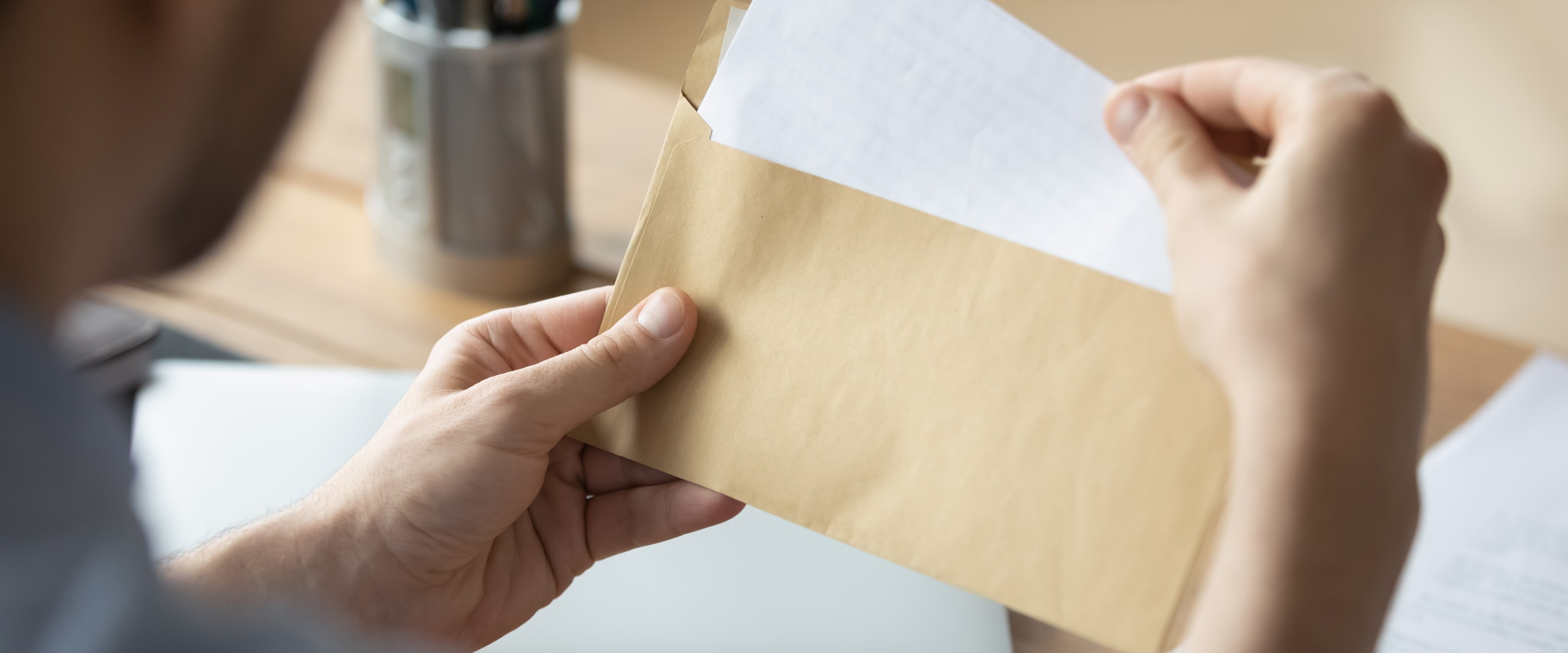 Man opening a letter