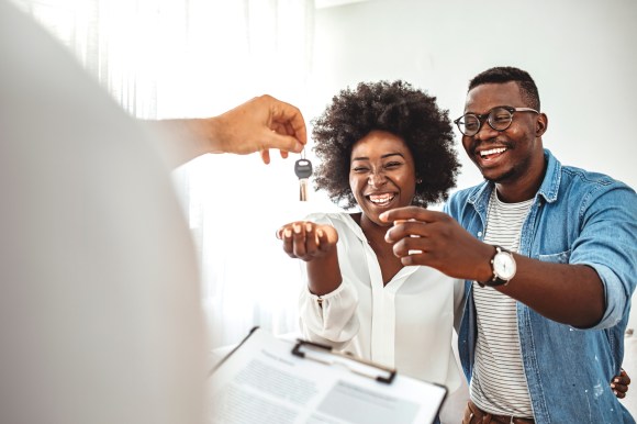 Landlord handing over keys to renters