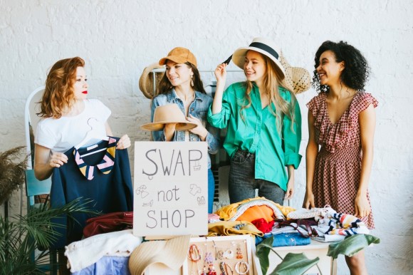 Young women participating in a clothing swap.