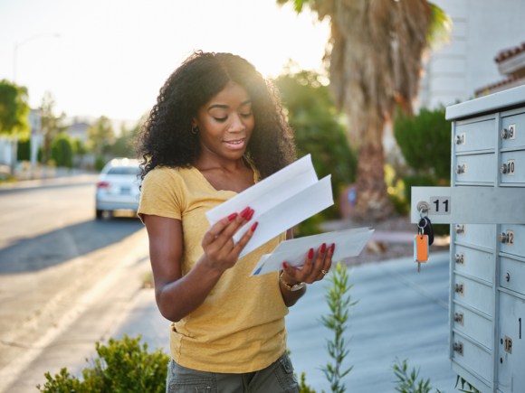 Black woman looking at her mail