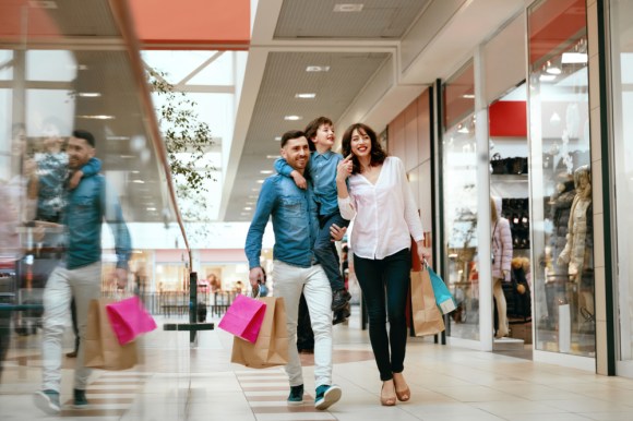 Family walking together with shopping bags.