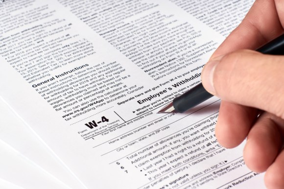 Close-up of someone filling out a W-4 form.