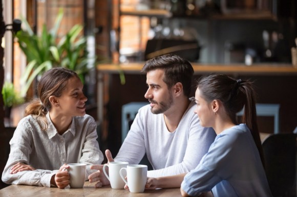 Woman having a business lunch with young couple.