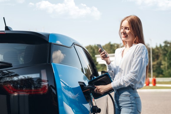 Woman fueling an electric vehicle.
