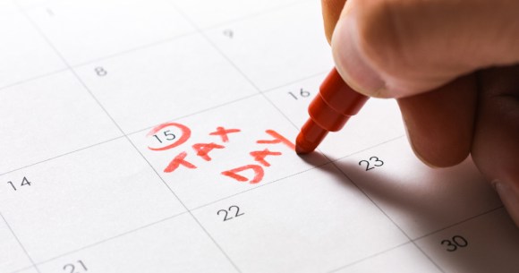 Close-up of someone circling Tax Day on their calendar.