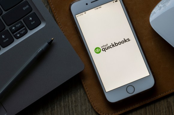 Close-up of the QuickBooks app opening on a smartphone.
