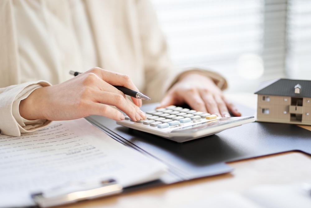 Close-up of a woman calculating property taxes.