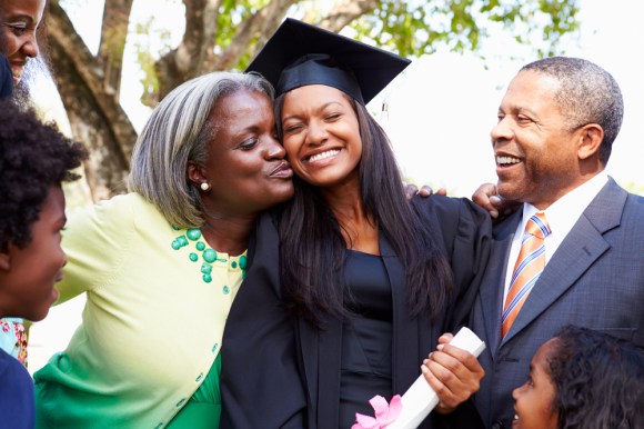 Student celebrates her graduation with her parents.
