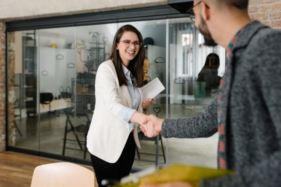 Young business professionals shaking hands.