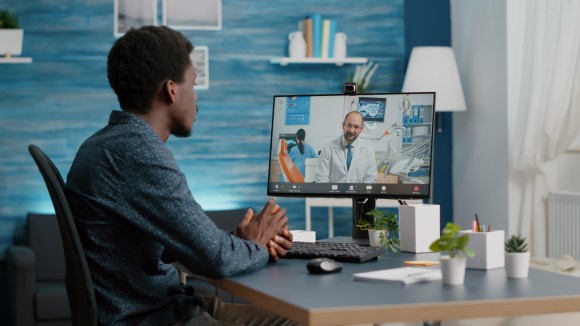 Young Black man online for a telehealth visit.