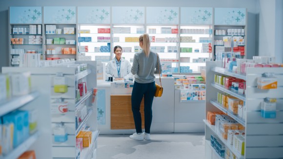 Woman buying medication at a drugstore.