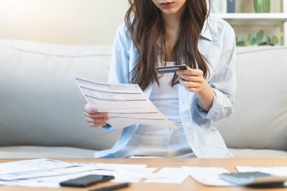 Woman looking at her credit card statement.