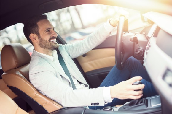 Man smiling and driving.