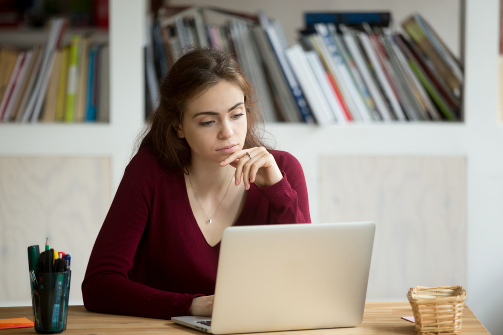 Young woman researching on her laptop.