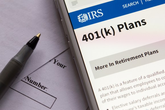 Close-up of a phone displaying a 401(k) information page on the IRS website.