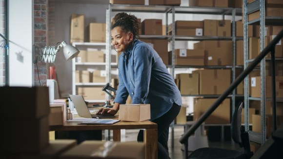 Business owner managing inventory in stock room.