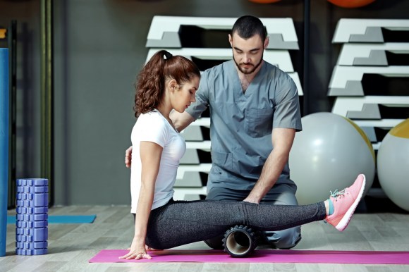 Woman doing exercises with physical therapist.
