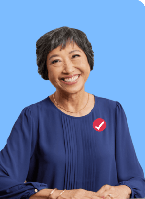 Asian woman proudly smiling. She has a dark blue blouse with a turbotax logo over the upper right chest. 