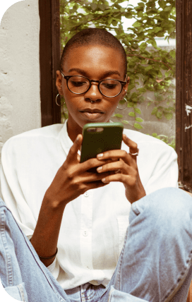 Photo of a user looking at their mobile phone